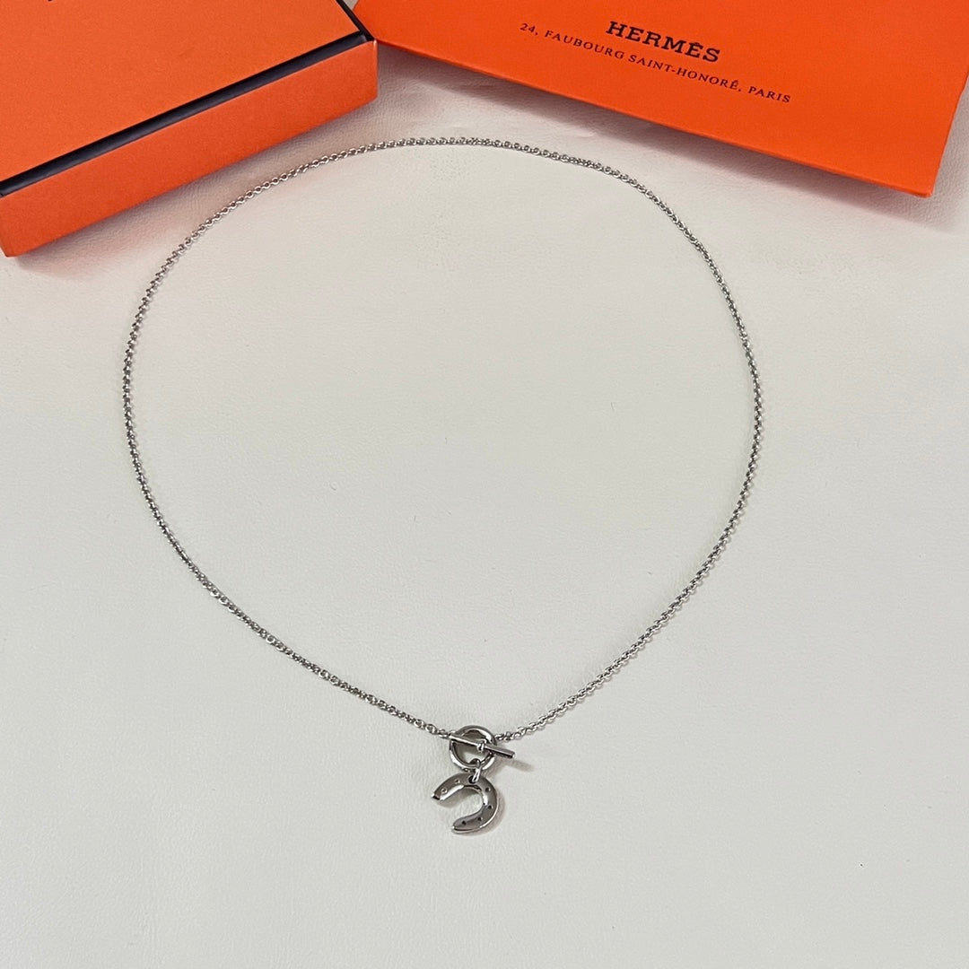 Martin Graham pendant necklace in polished metal-tone – close-up detail