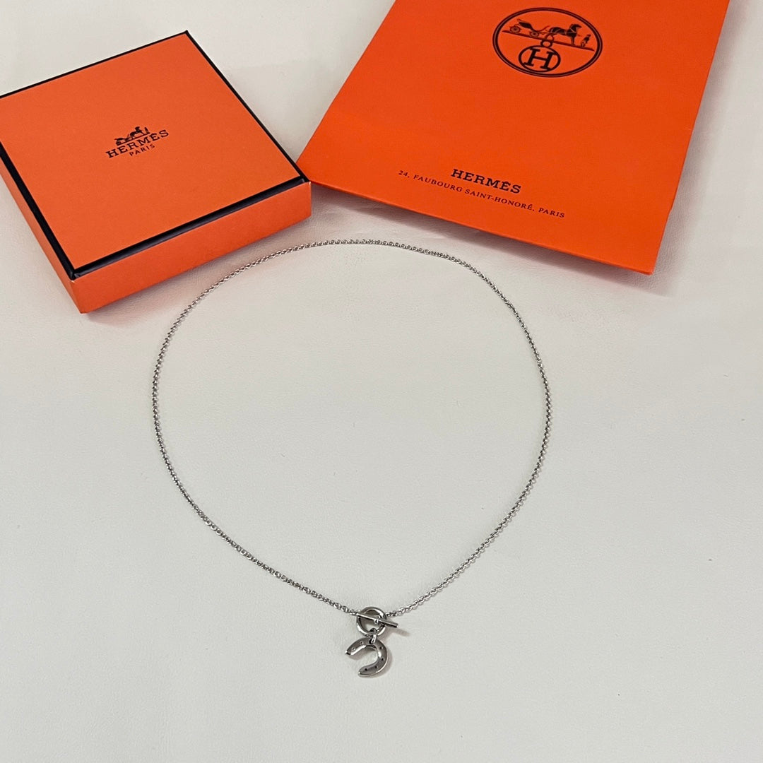 Martin Graham pendant necklace in polished metal-tone – front product view