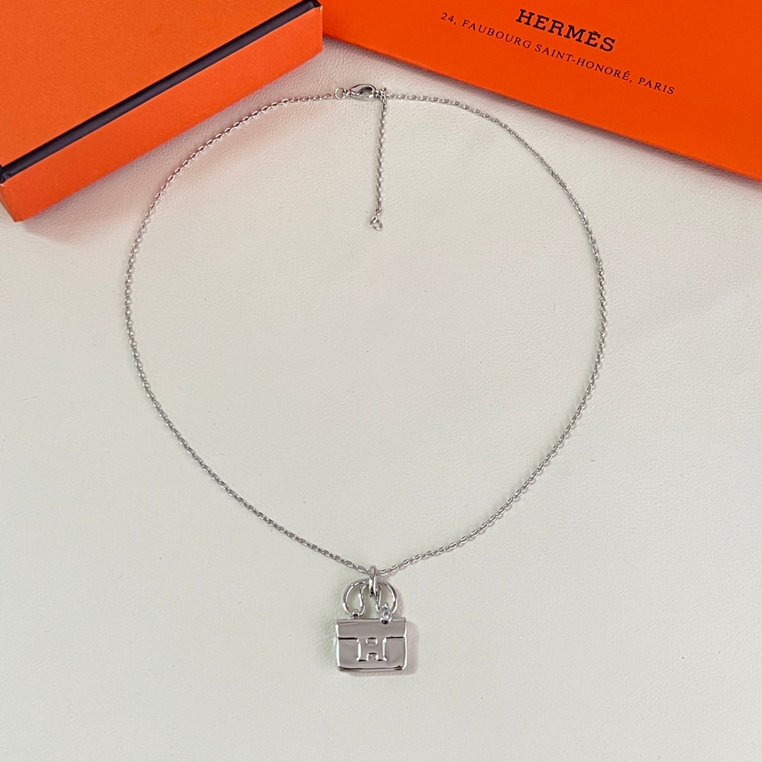 Martin Graham pendant necklace in polished metal-tone – close-up detail