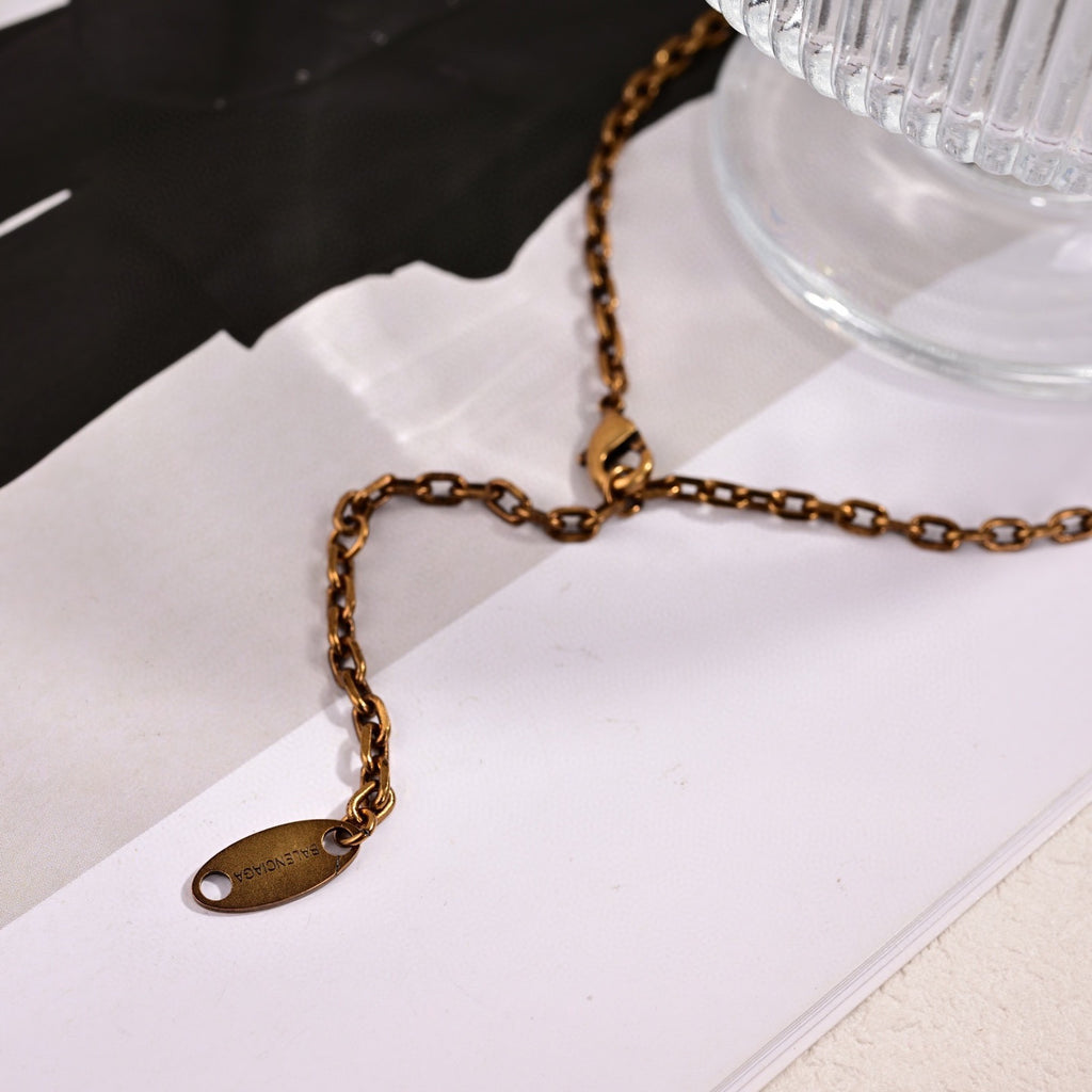 Martin Graham pendant necklace in polished metal-tone – close-up detail