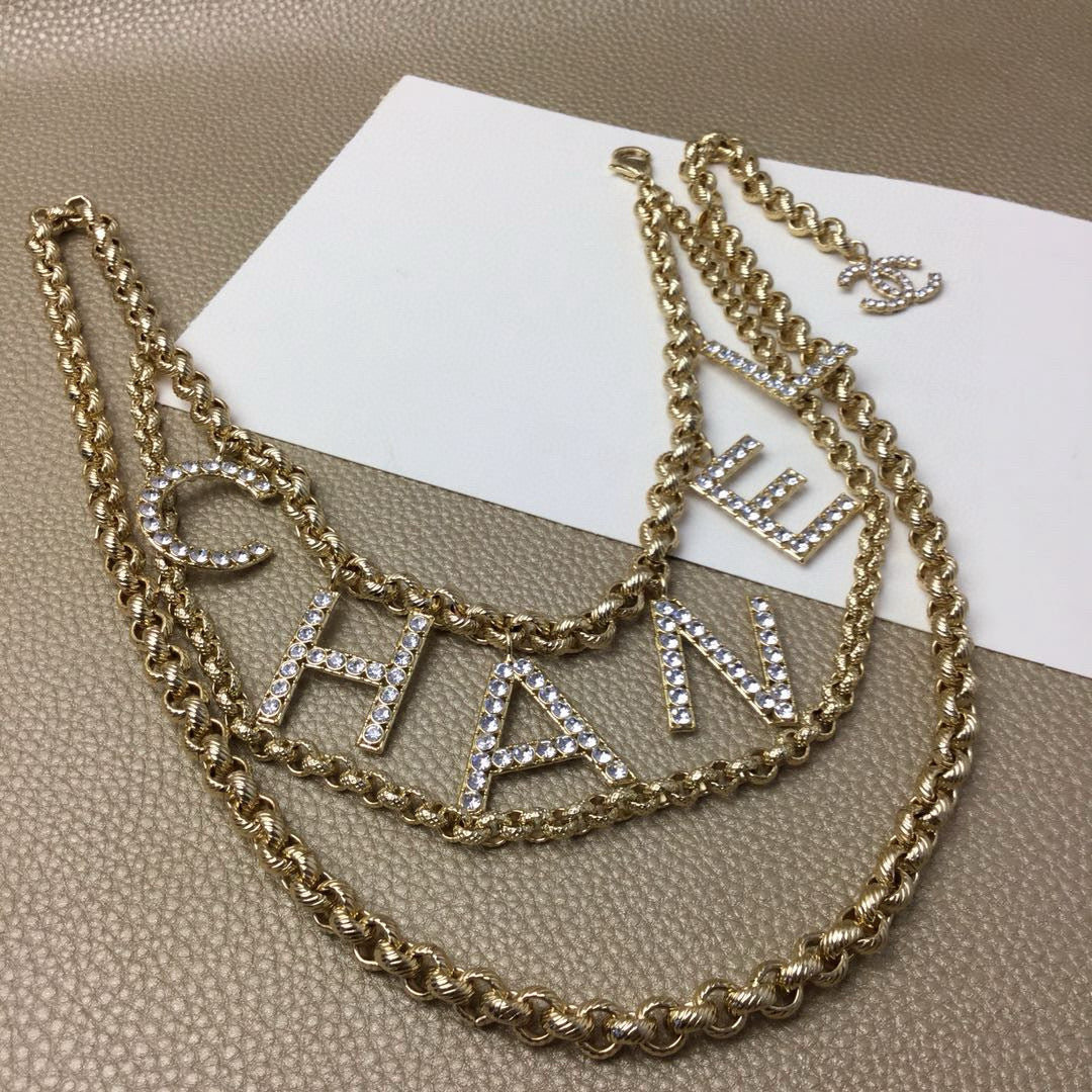 Signature Emblem Jewelry Accessory in Polished Metal-Tone – White Detail detail view