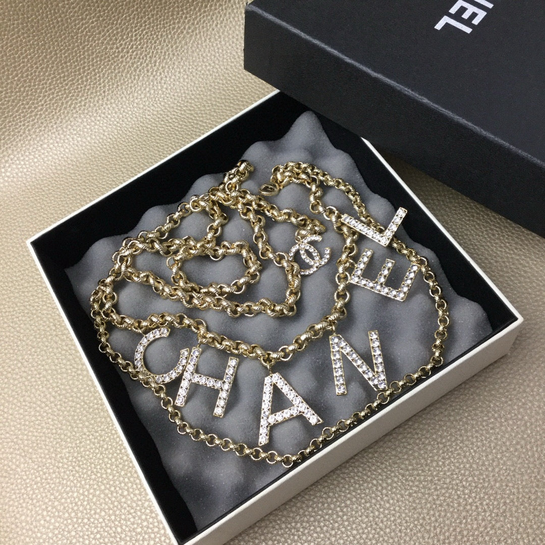 Signature Emblem Jewelry Accessory in Polished Metal-Tone – White Detail front product view