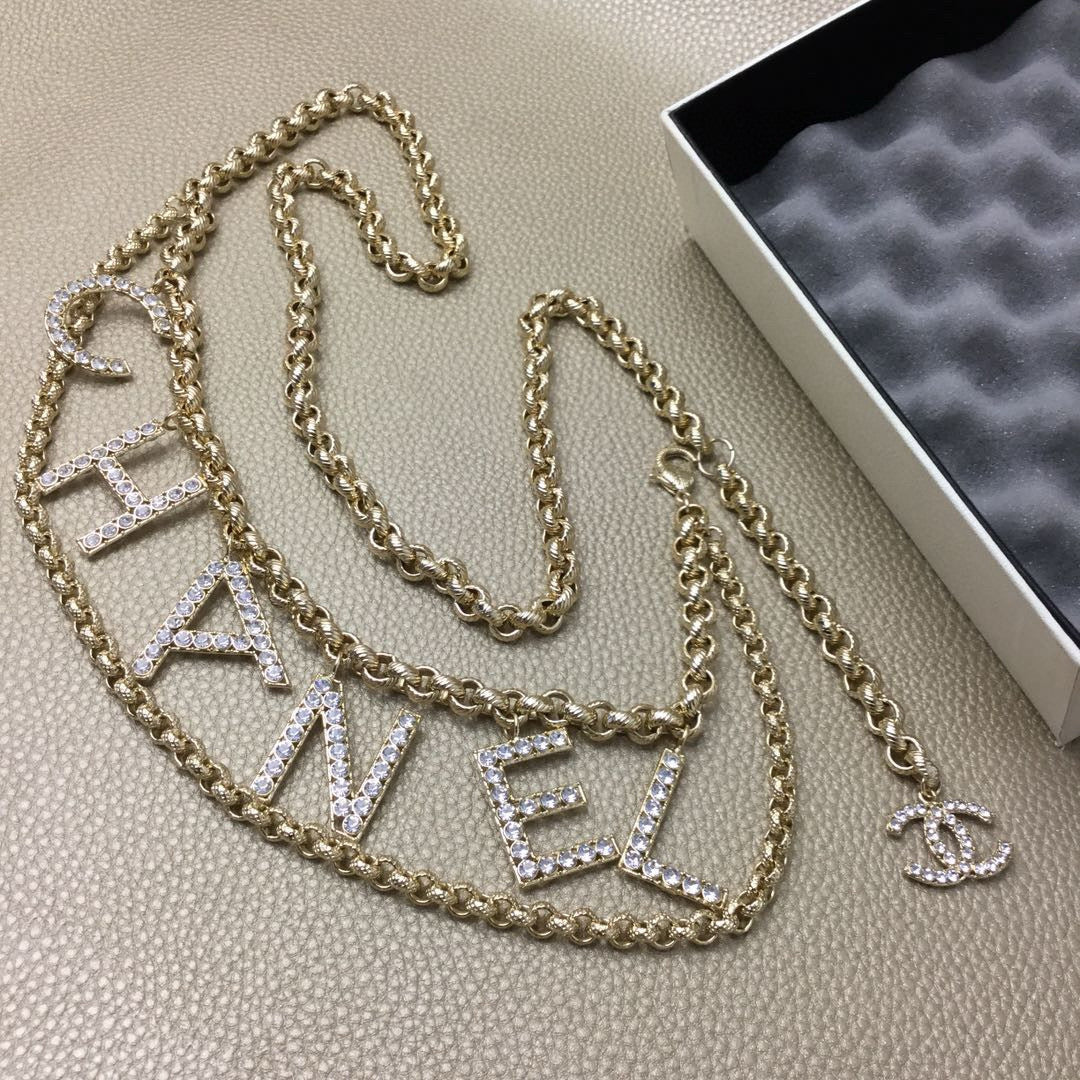 Signature Emblem Jewelry Accessory in Polished Metal-Tone – White Detail styled product view