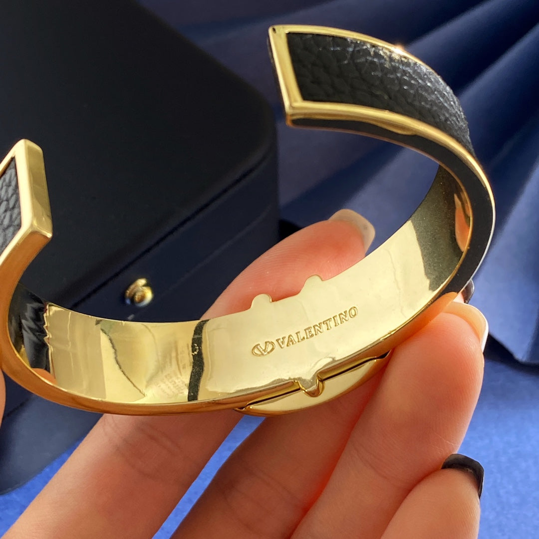 V Emblem Cuff Bracelet in Gold-Tone – Black close-up view