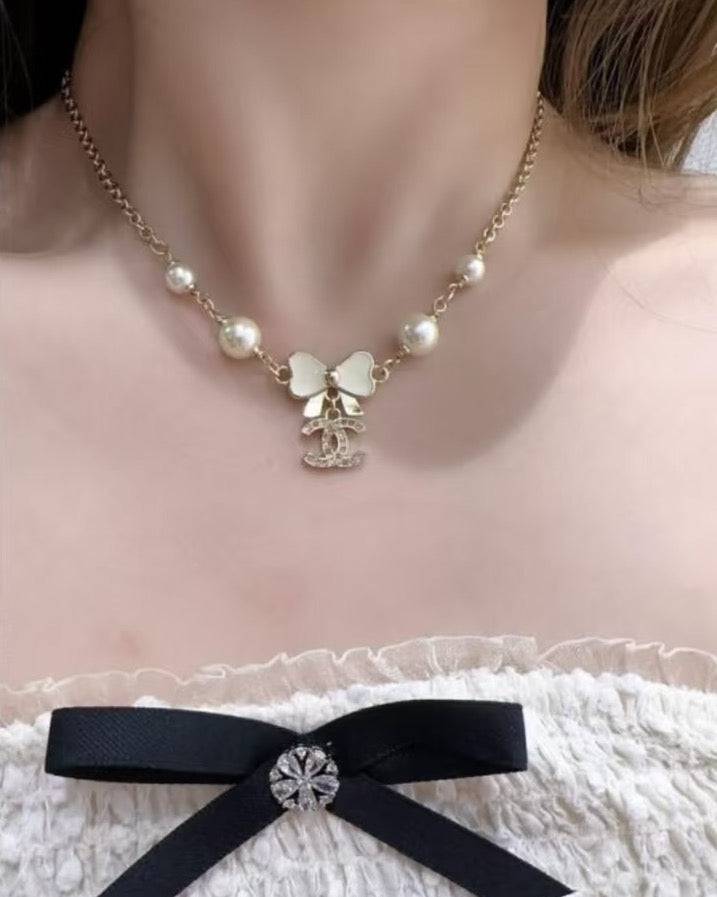 Bow Pendant Necklace in Polished Metal-Tone detail view