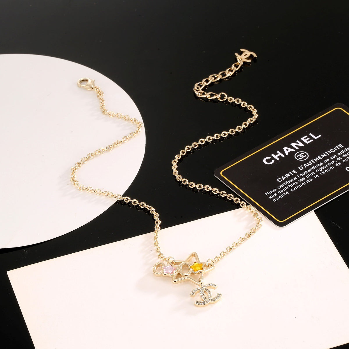 Double-C Emblem Crystal-Accent Pendant Necklace – Star Detail close-up detail