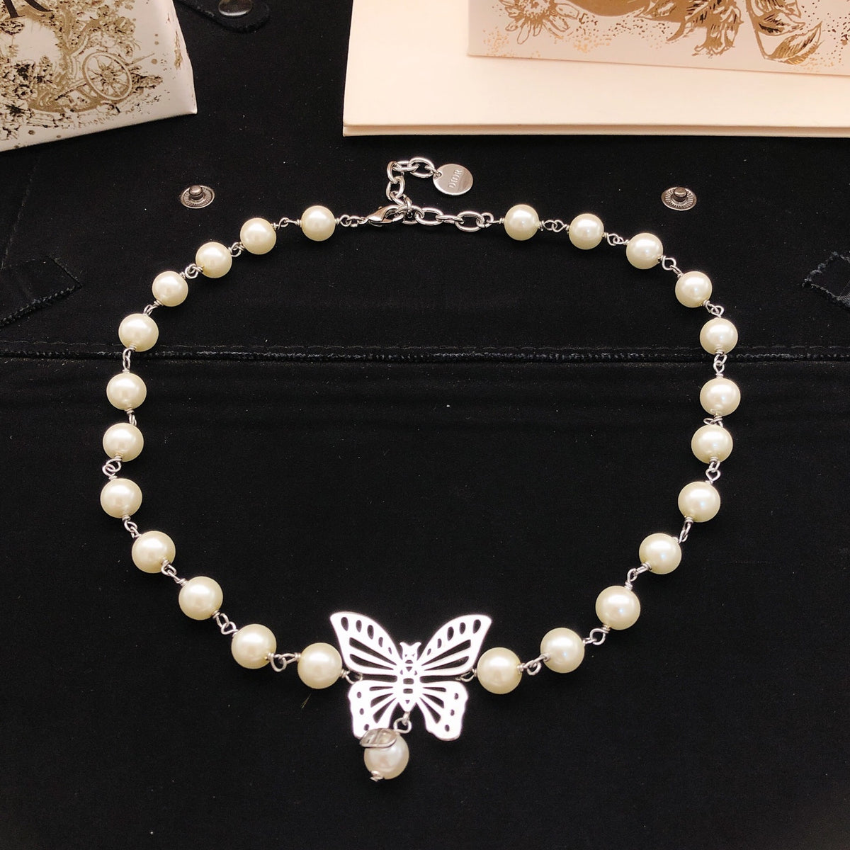 Bow & Butterfly Motif Pendant Necklace in Polished Metal-Tone with Pearl-Style Detail – Design 002 front view