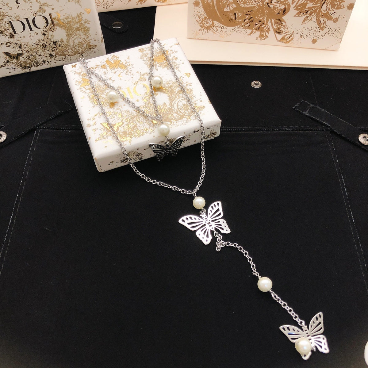 Bow & Butterfly Motif Pendant Necklace in Silver-Tone with Layered Detail detail view