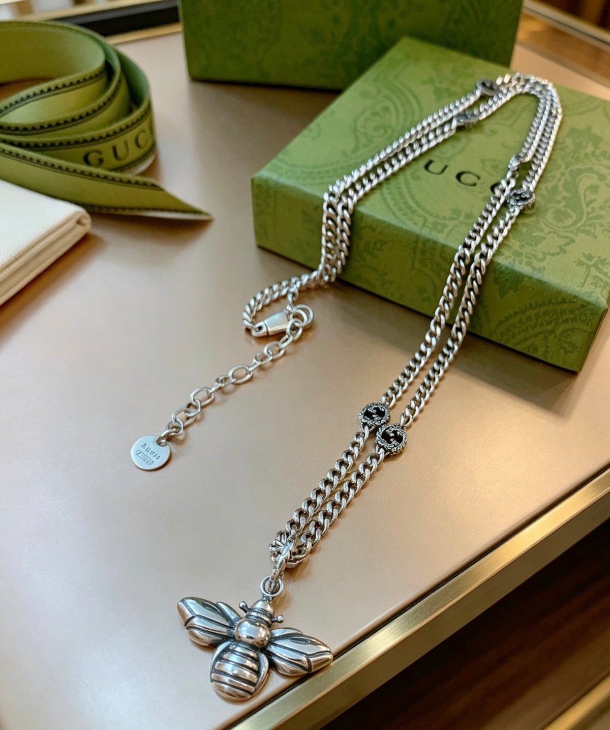 Double-G Emblem Pendant Necklace in Polished Metal-Tone – Bee Detail front product view