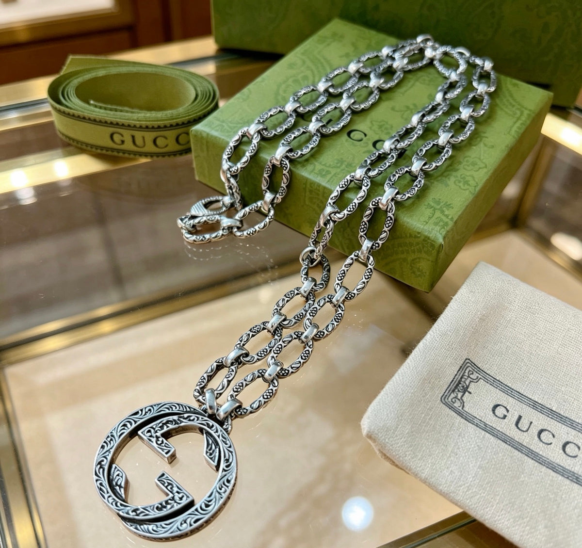 Martin Graham pendant necklace in polished metal-tone – close-up detail