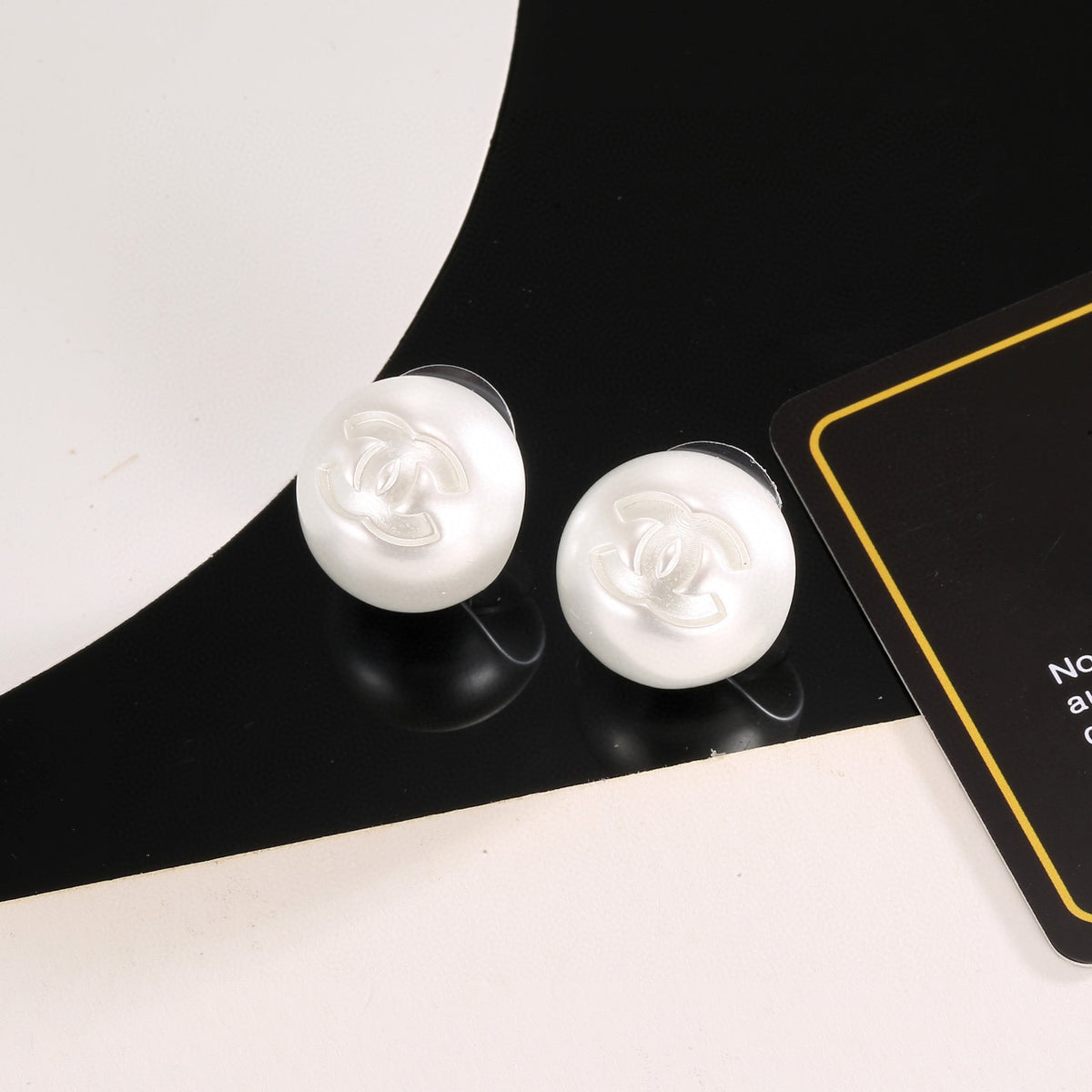 Double-C Emblem Stud Earrings in Polished Metal-Tone – White Detail – Design 003 main product view