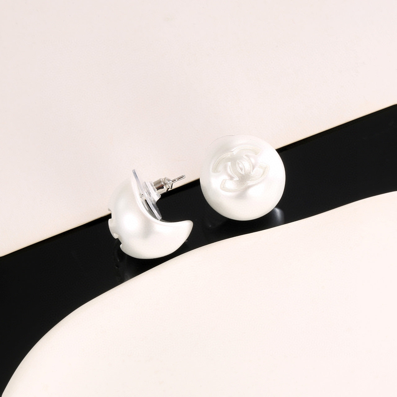 Double-C Emblem Stud Earrings in Polished Metal-Tone – White Detail – Design 003 styled product view