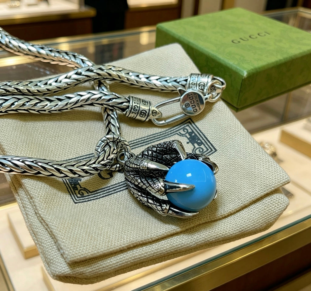 Double-G Emblem Pendant Necklace in Polished Metal-Tone – Turquoise Detail close-up detail