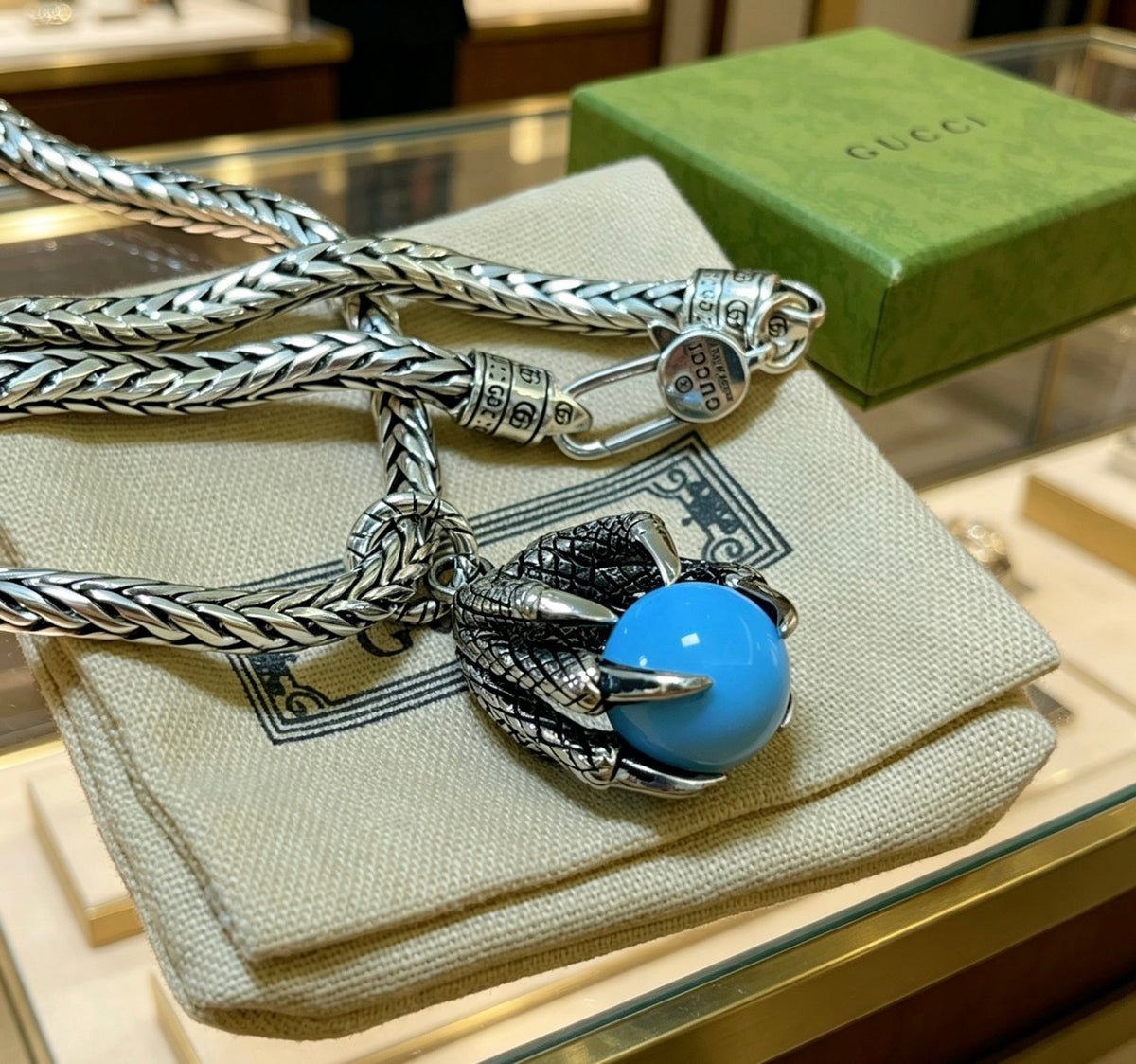 Double-G Emblem Pendant Necklace in Polished Metal-Tone – Turquoise Detail close-up detail