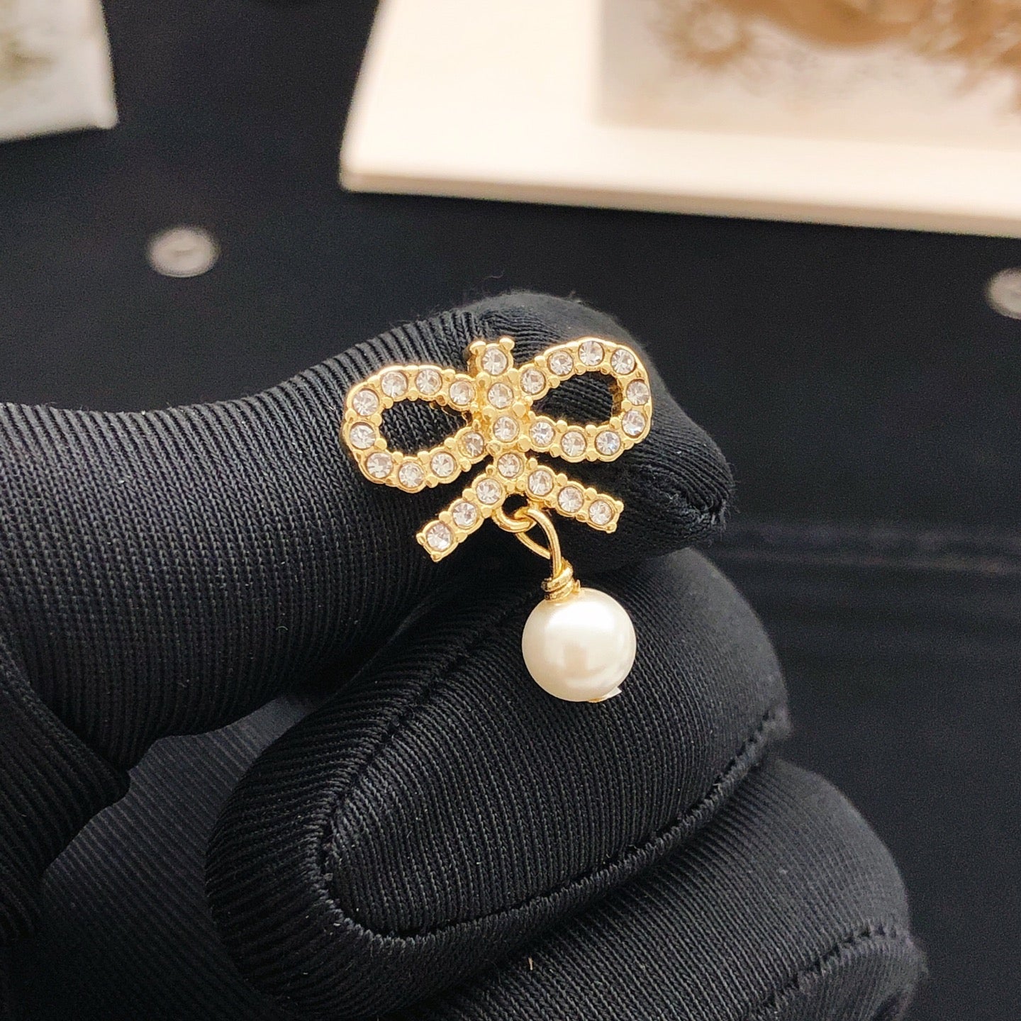Bow & Butterfly Motif Stud Earrings in Polished Metal-Tone with Pearl-Style Detail front view