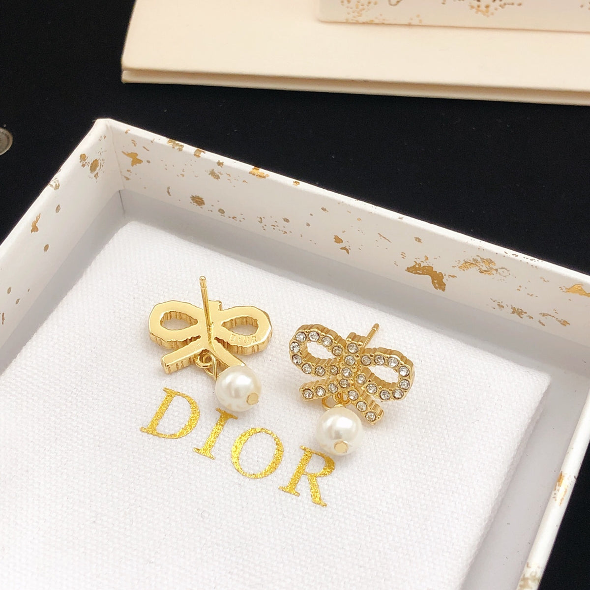 Bow & Butterfly Motif Stud Earrings in Polished Metal-Tone with Pearl-Style Detail styled view