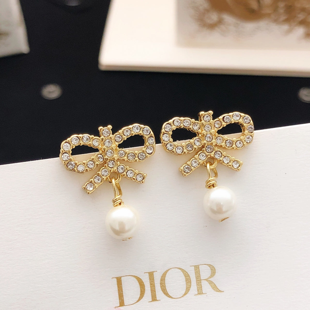 Bow & Butterfly Motif Stud Earrings in Polished Metal-Tone with Pearl-Style Detail main product view