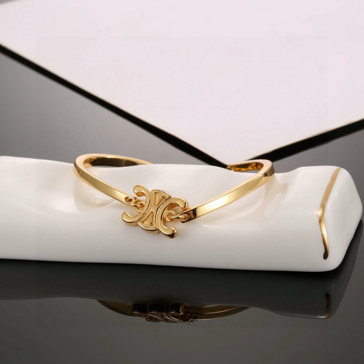 Triomphe-Inspired Emblem Cuff Bracelet in Gold-Tone front view