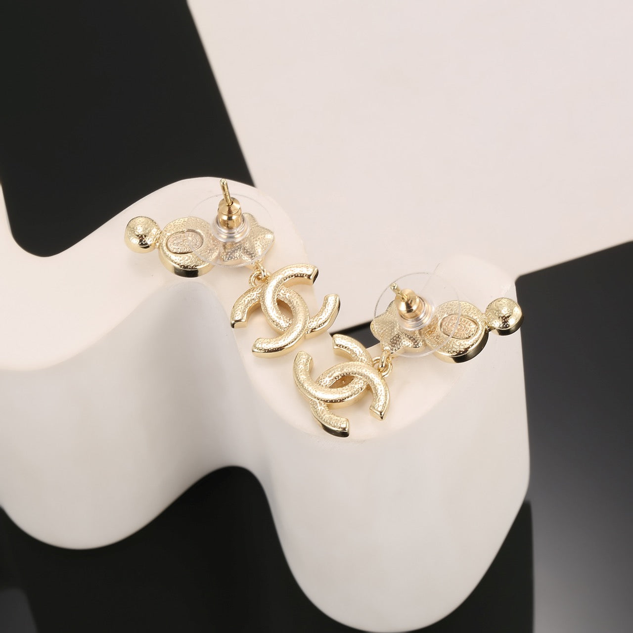 Double-C Emblem Stud Earrings in Gold-Tone – Star Detail – Design 008 side detail