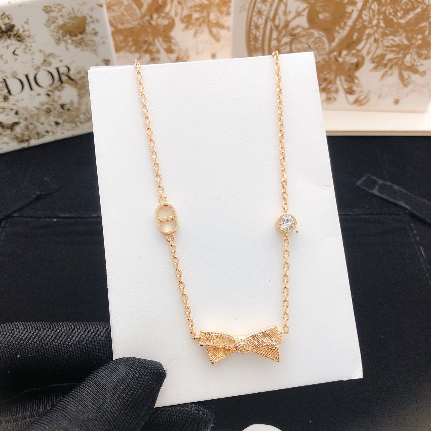 Bow & Butterfly Motif Pendant Necklace in Rose-Gold-Tone detail view