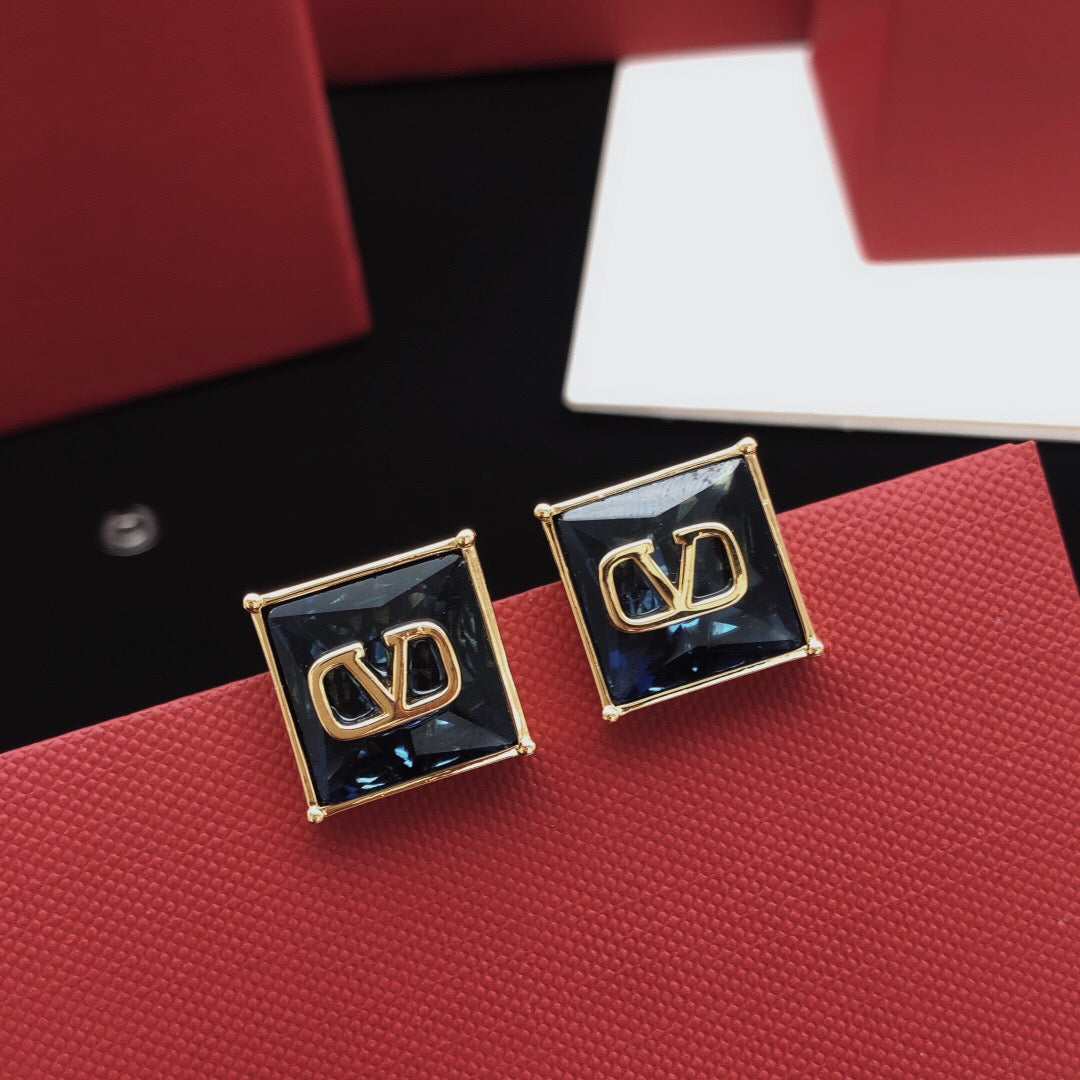 Signature Emblem Stud Earrings in Polished Metal-Tone – Red detail view