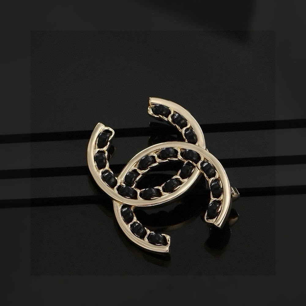 Double-C Emblem Brooch in Polished Metal-Tone – Black Detail detail view
