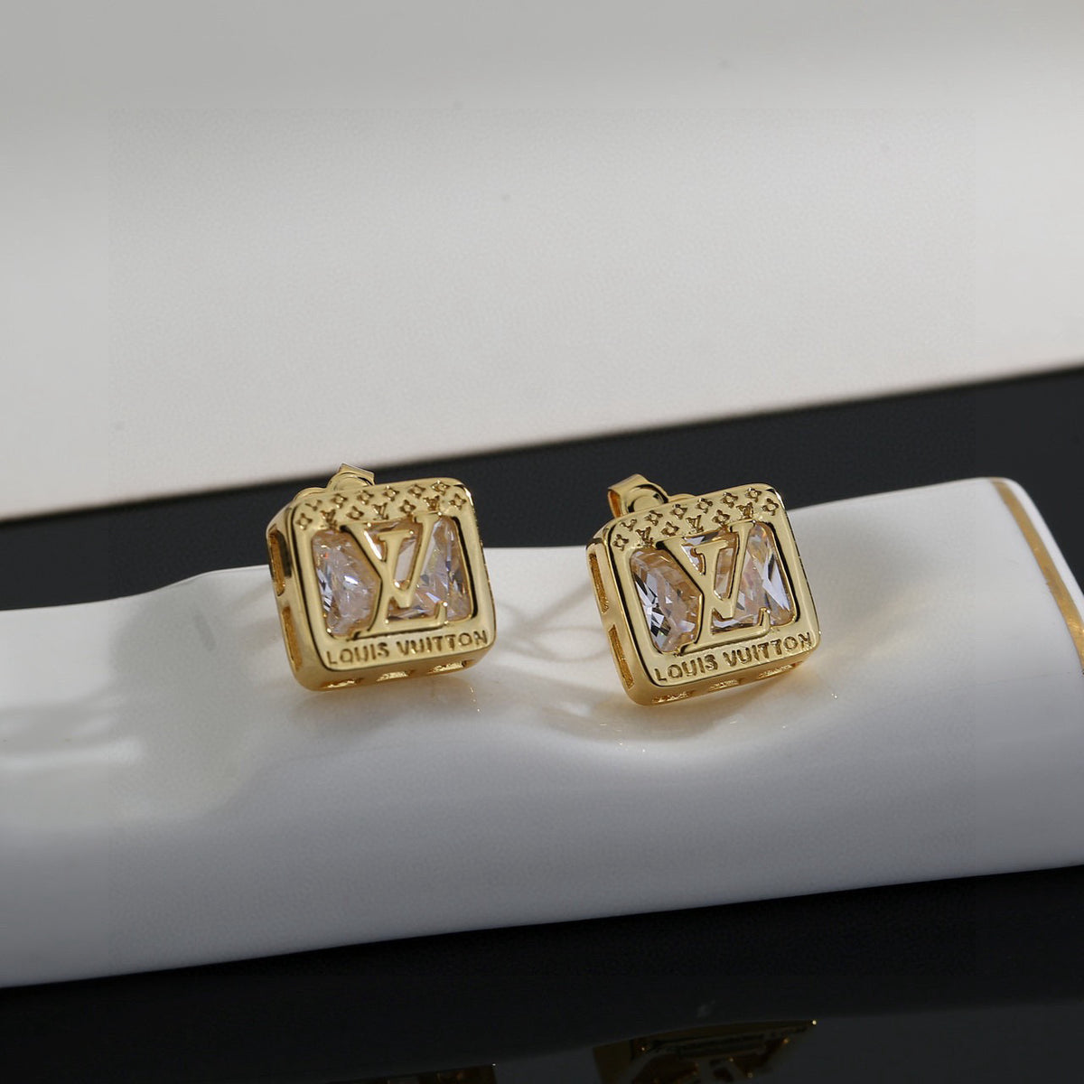 Martin Graham stud earrings in polished metal-tone – close-up detail
