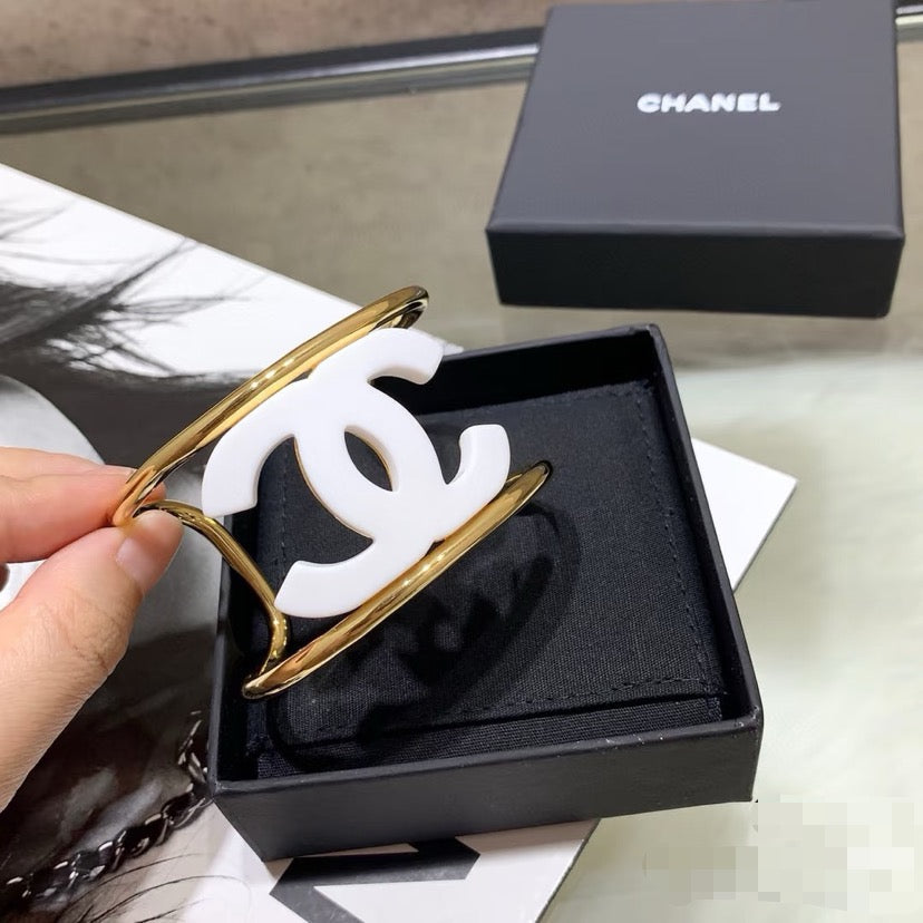 Signature Emblem Bangle in Polished Metal-Tone – White Detail front product view