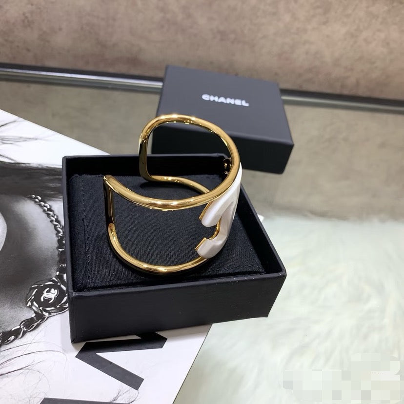 Signature Emblem Bangle in Polished Metal-Tone – White Detail side detail
