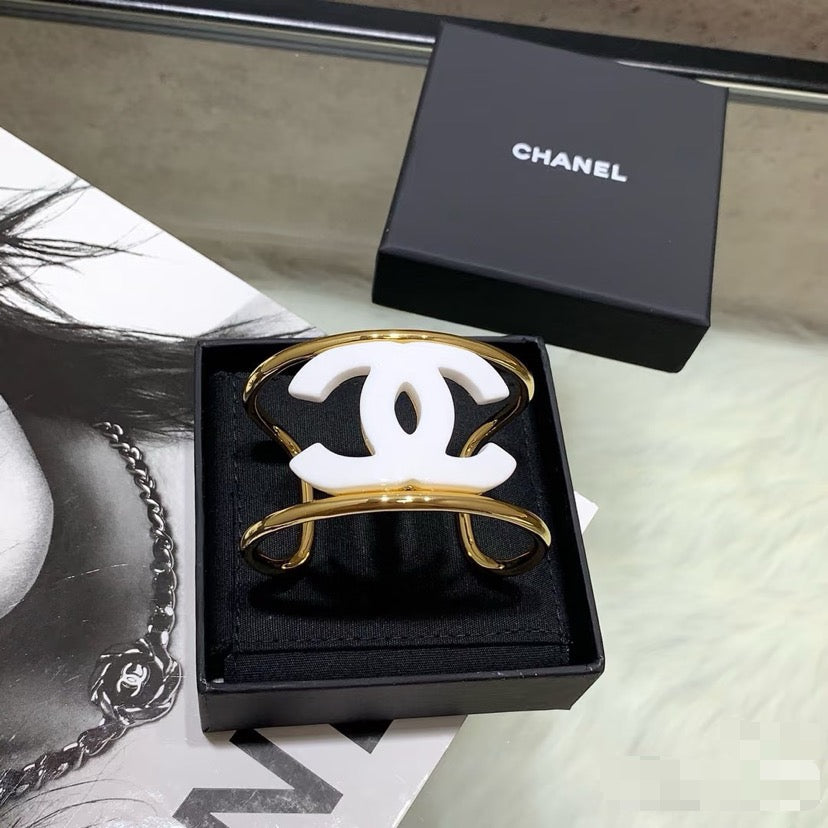 Signature Emblem Bangle in Polished Metal-Tone – White Detail main product view