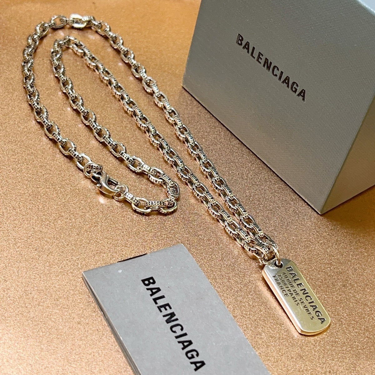 Martin Graham pendant necklace in polished metal-tone – side detail