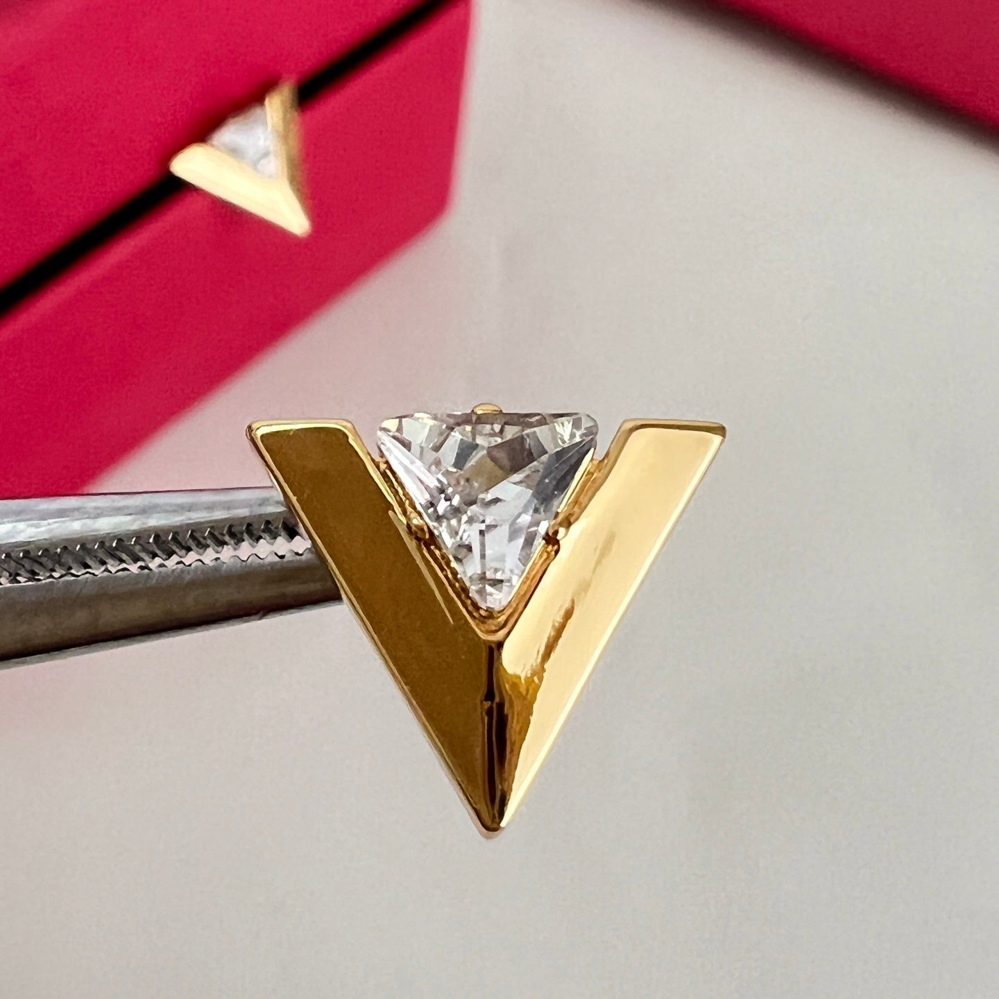 Signature Emblem Stud Earrings in Polished Metal-Tone – Design 01 close-up view