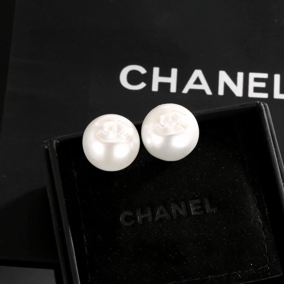 Double-C Emblem Stud Earrings in Polished Metal-Tone – White Detail close-up detail