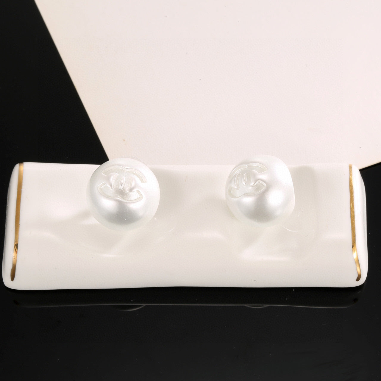 Double-C Emblem Stud Earrings in Polished Metal-Tone – White Detail – Design 002 side detail