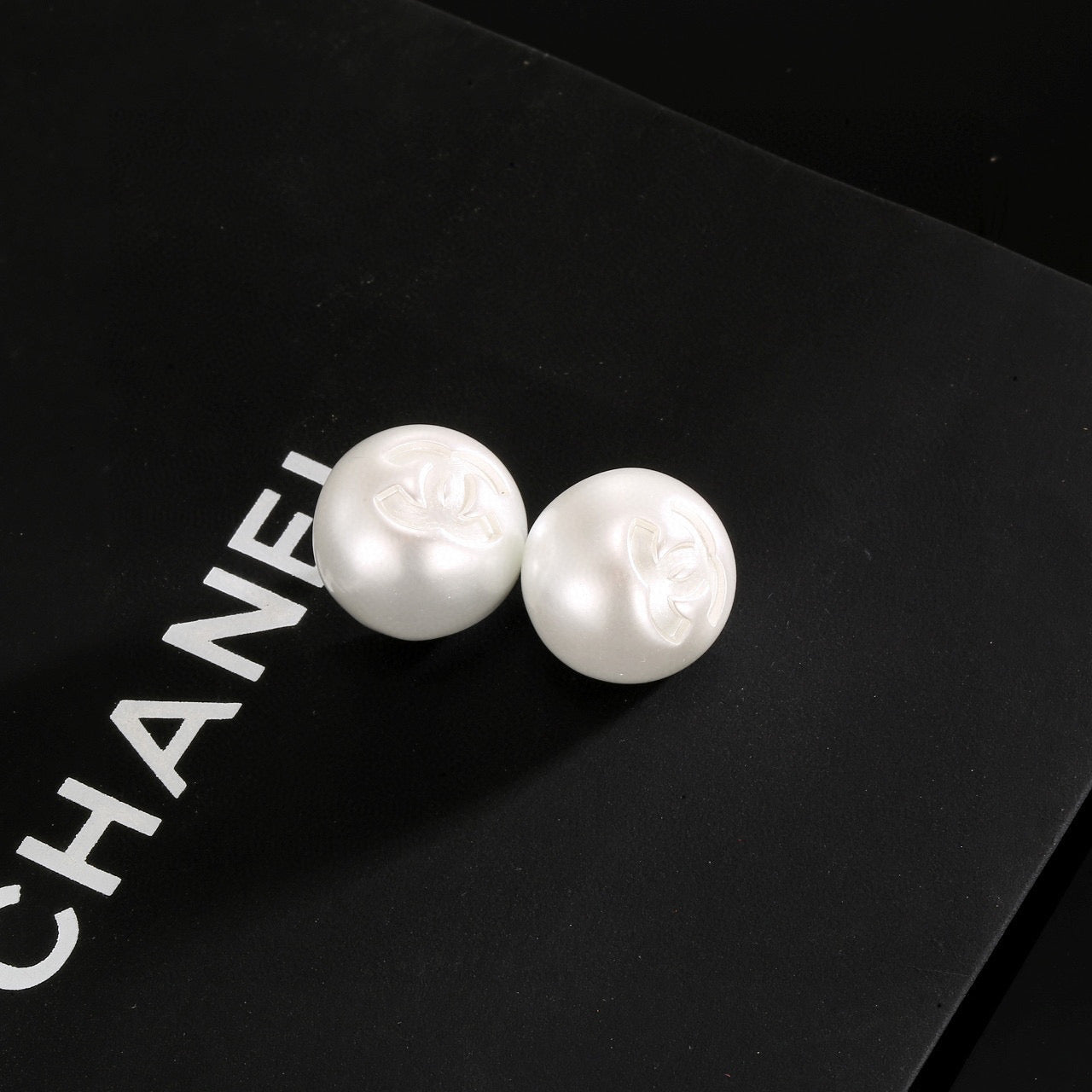 Double-C Emblem Stud Earrings in Polished Metal-Tone – White Detail – Design 002 front product view