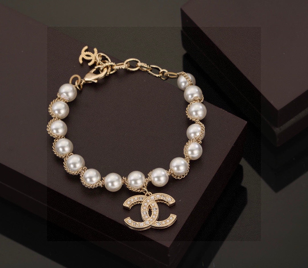 Double-C Emblem Bracelet in Polished Metal-Tone – Pearl Detail front product view