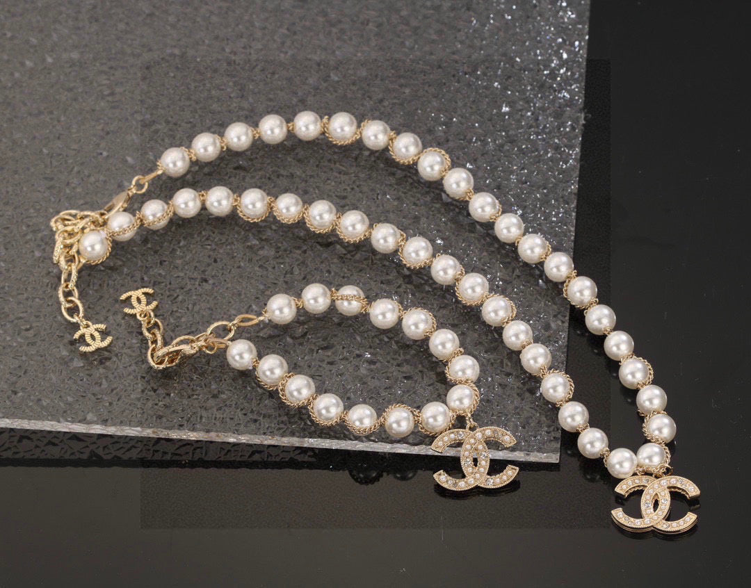 Double-C Emblem Bracelet in Polished Metal-Tone – Pearl Detail front product view