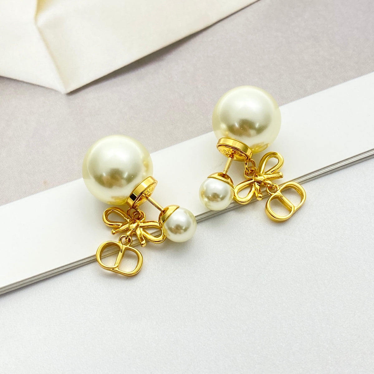 Bow & Butterfly Motif Stud Earrings in Gold-Tone with Pearl-Style Detail – Design 001 front view