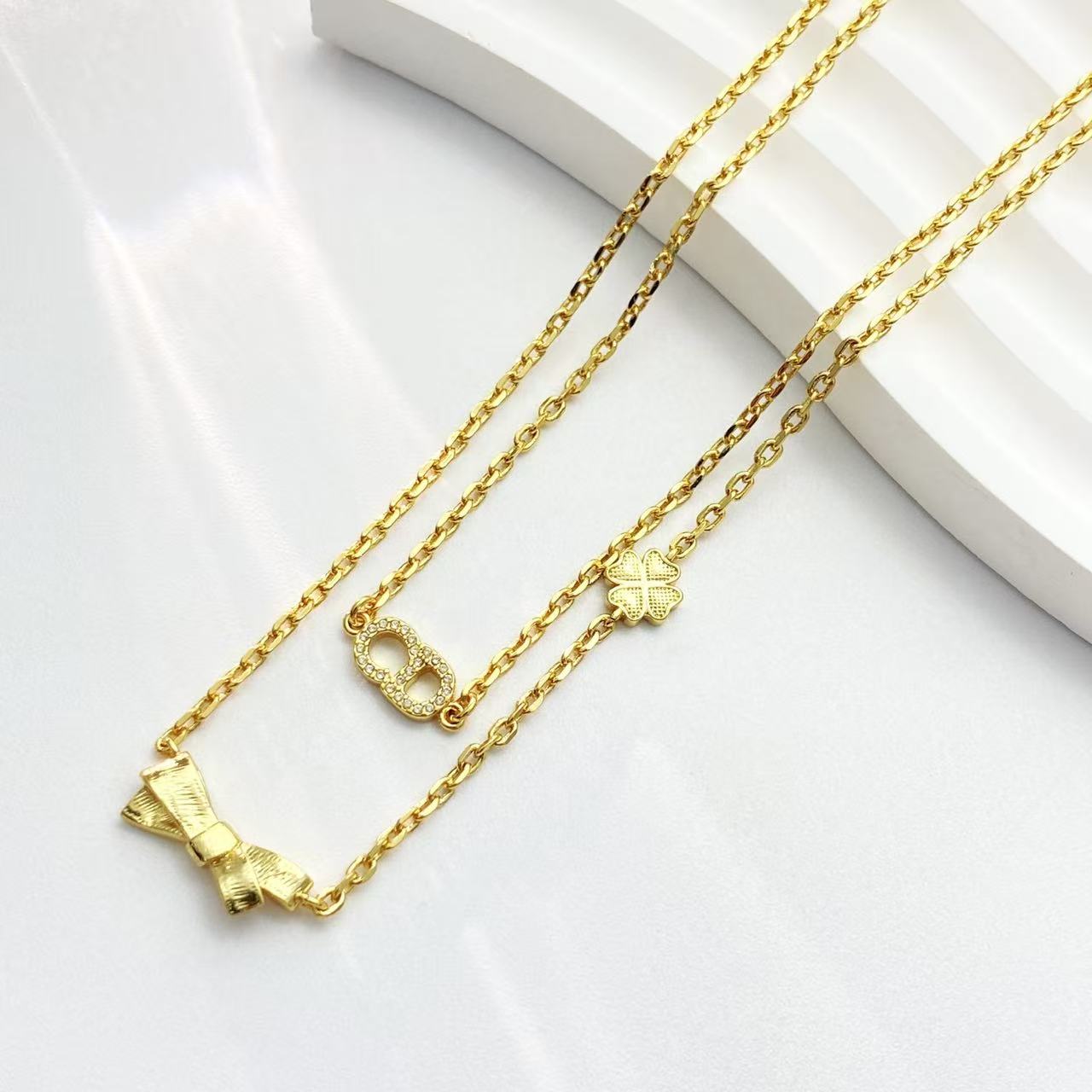 Bow & Butterfly Motif Pendant Necklace in Polished Metal-Tone with Layered Detail – Design 001 front view