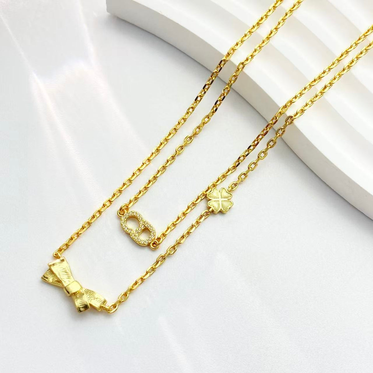 Bow & Butterfly Motif Pendant Necklace in Polished Metal-Tone with Layered Detail – Design 002 front view